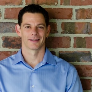 A photo of Dr. Brad Rappaport in front of a brick wall